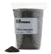 Old Potters semillas de girasol negro para aves, ideales para atraer aves en exteriores.