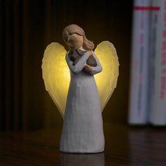 DecorSmart luz recuerdo alas: iluminación cálida que acompaña momentos de duelo y memoria.